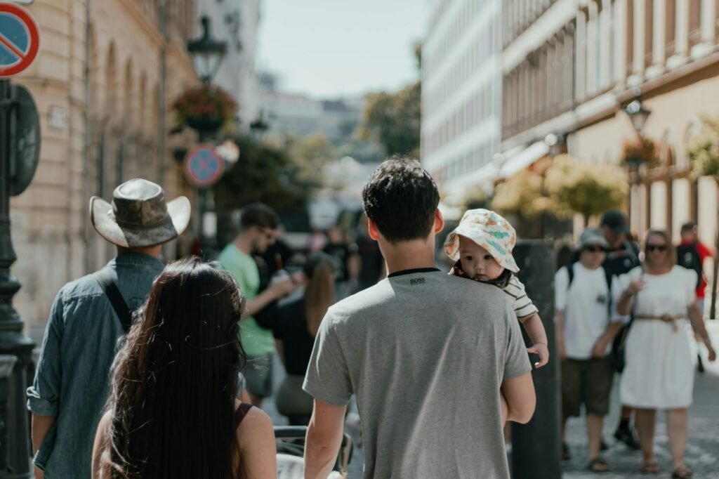 a family walking down a street with a child