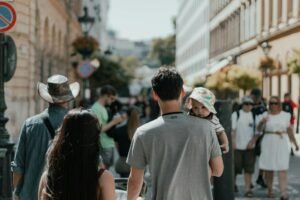 a family walking down a street with a child